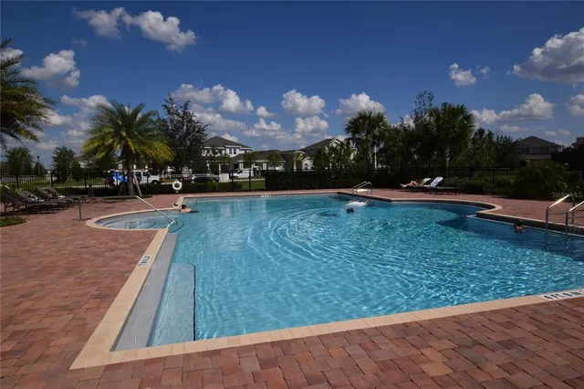 a view of a swimming pool with an outdoor seating and a yard