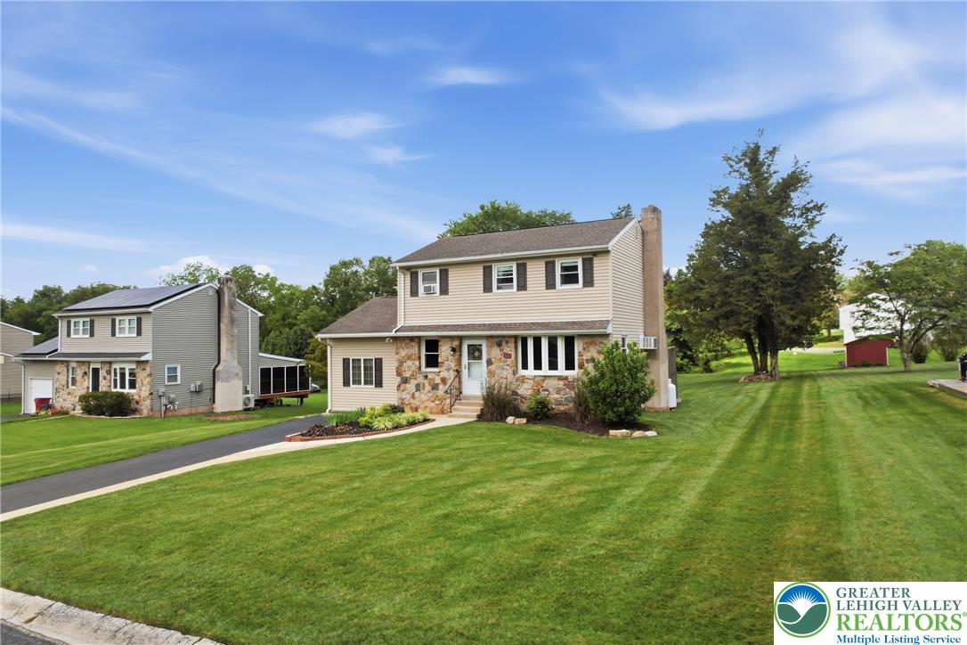 1385 Woodmere Road Pottstown, PA 19464 - Photo 57 of 57 A classic two-story residence presents a meticulously maintained lawn and charming stone and siding facade.