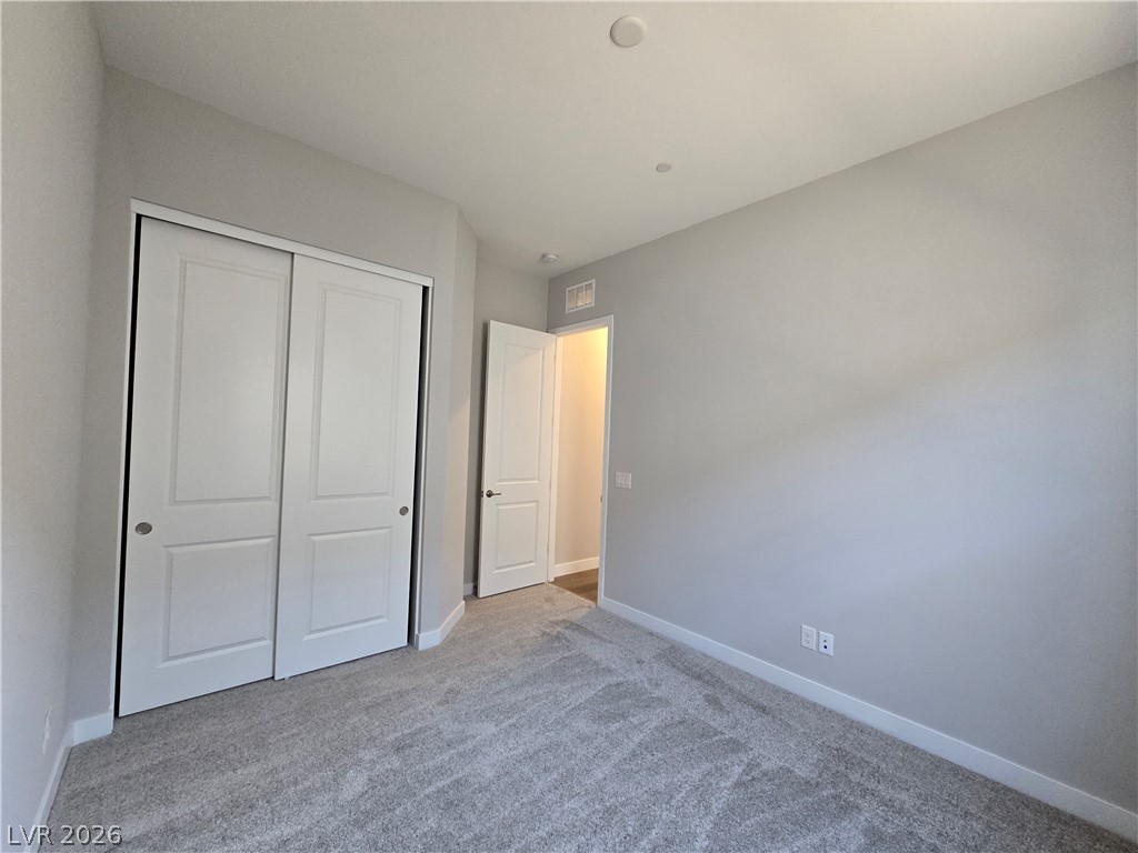852 Weston Ridge Street Henderson, NV 89011 - Photo 9 of 28 An inviting sleeping space with plush carpet and ample closet storage awaits its next occupant.