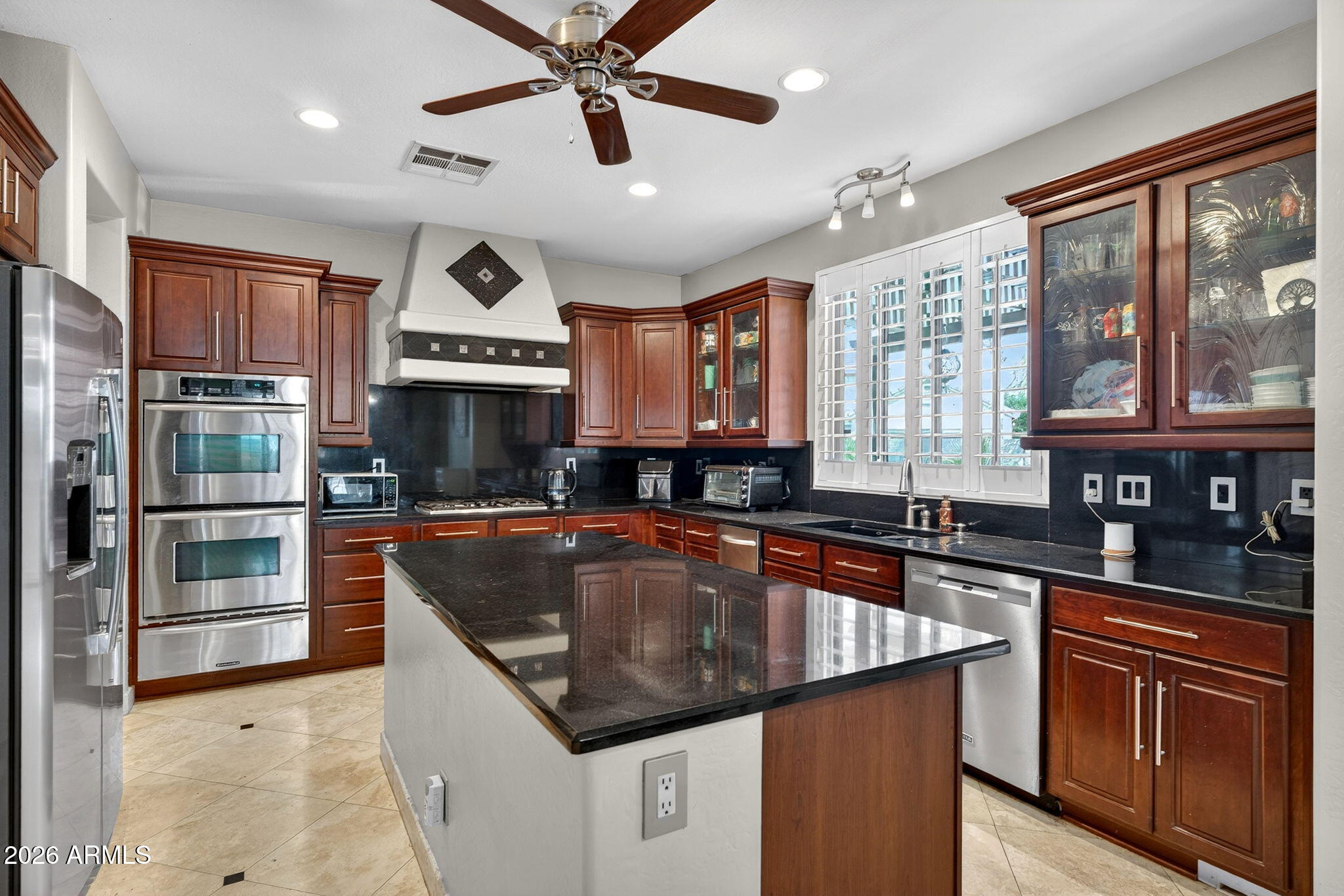 1729 South Reseda Street Gilbert, AZ 85295 - Photo 13 of 52 a kitchen with stainless steel appliances granite countertop a sink a stove and a refrigerator
