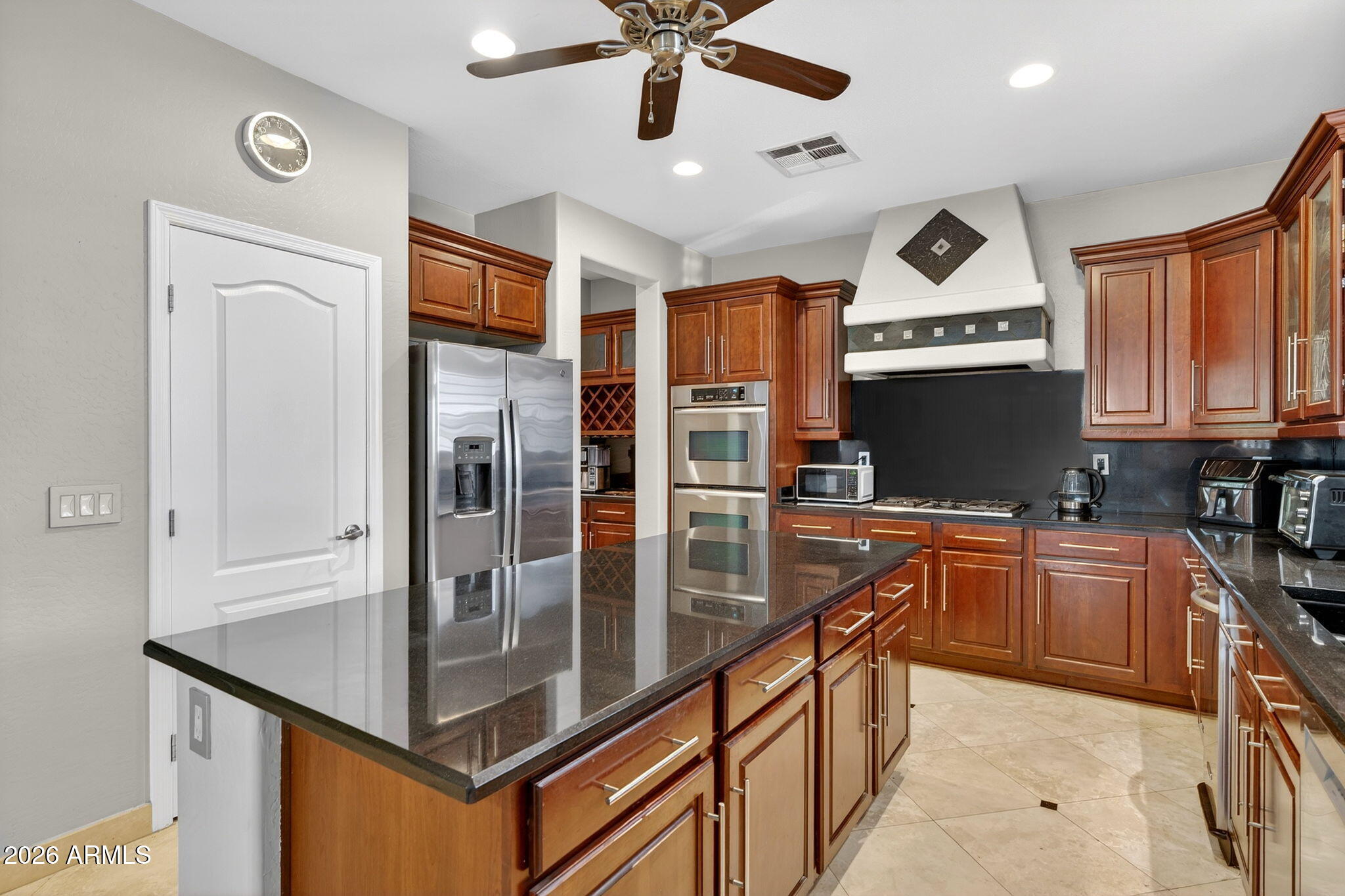 1729 South Reseda Street Gilbert, AZ 85295 - Photo 14 of 52 a kitchen with stainless steel appliances granite countertop a sink a stove and a refrigerator