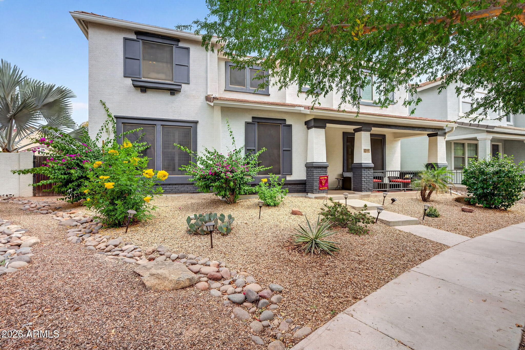 1729 South Reseda Street Gilbert, AZ 85295 - Photo 3 of 52 a front view of a house with garden