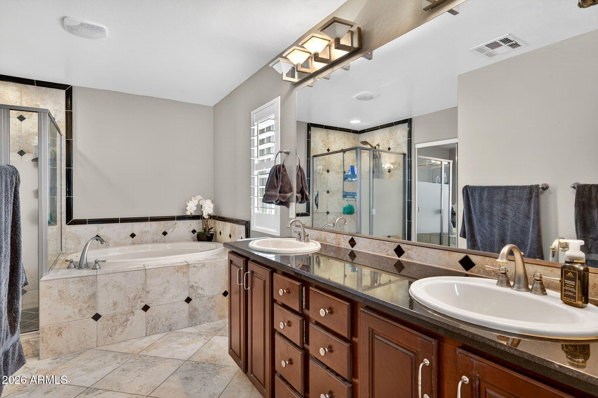 1729 South Reseda Street Gilbert, AZ 85295 - Photo 32 of 52 a bathroom with double vanity sinks double vanity tub shower and a mirror
