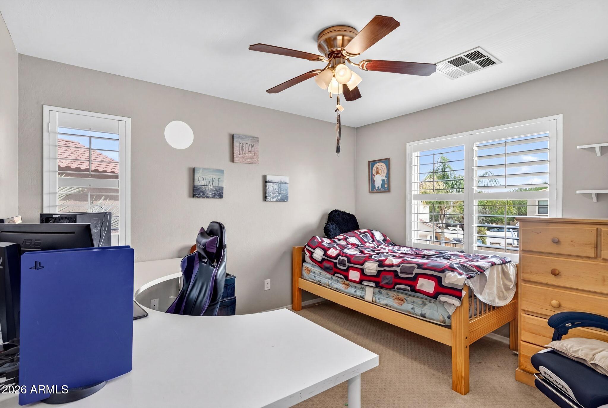 1729 South Reseda Street Gilbert, AZ 85295 - Photo 35 of 52 a bed room with furniture and a chandelier