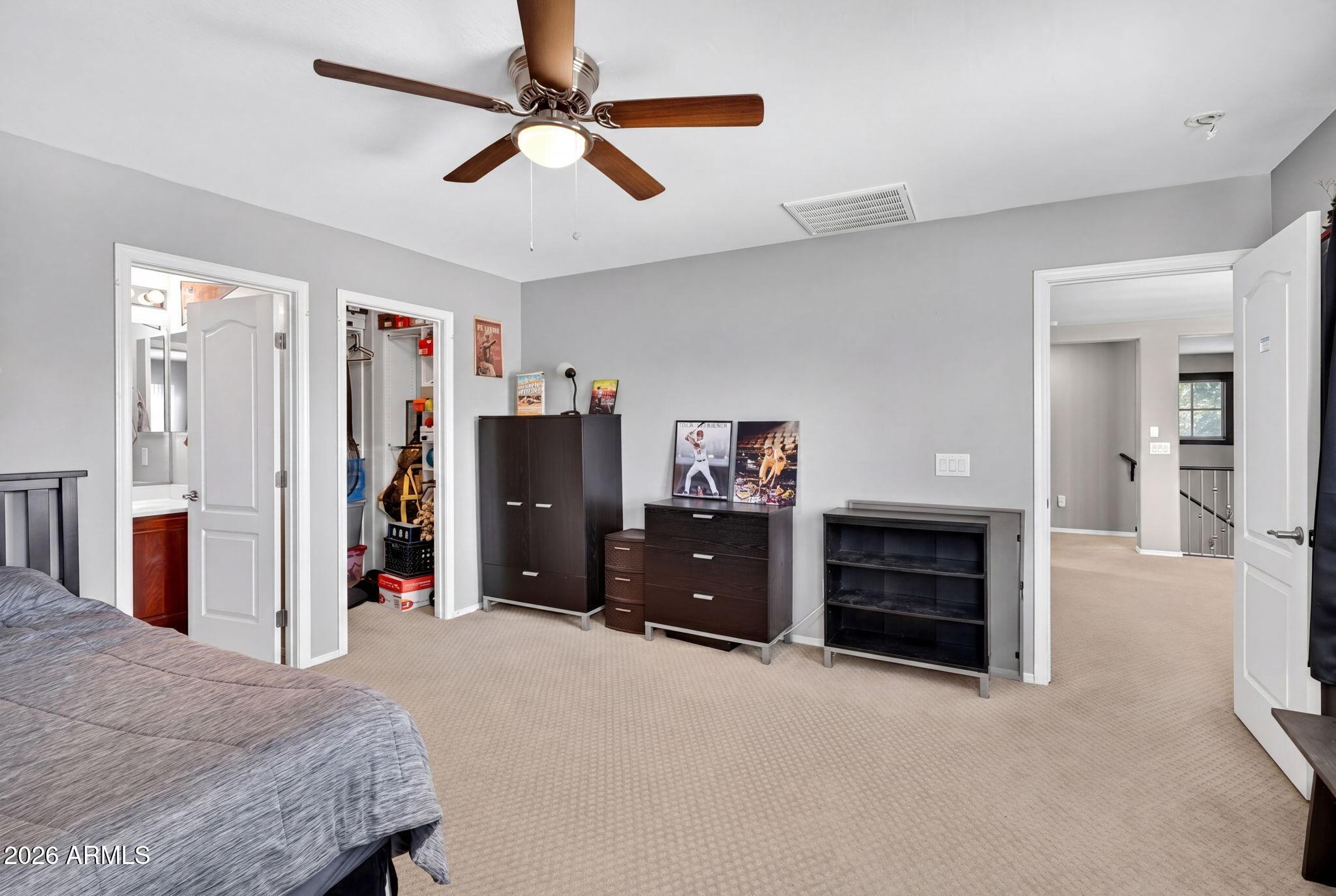 1729 South Reseda Street Gilbert, AZ 85295 - Photo 40 of 52 a bedroom with a bed and a chandelier