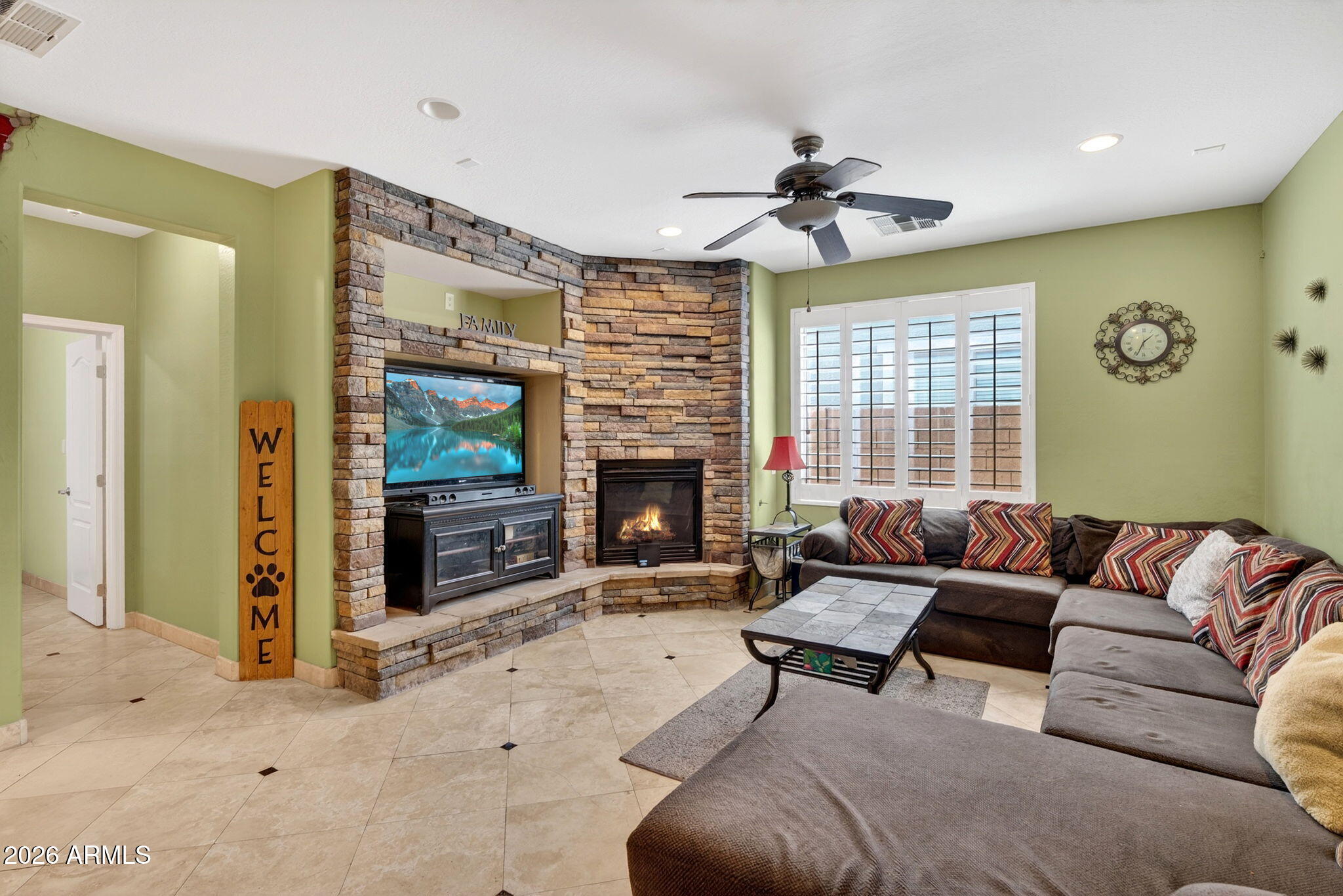 1729 South Reseda Street Gilbert, AZ 85295 - Photo 9 of 52 a living room with furniture and a fireplace