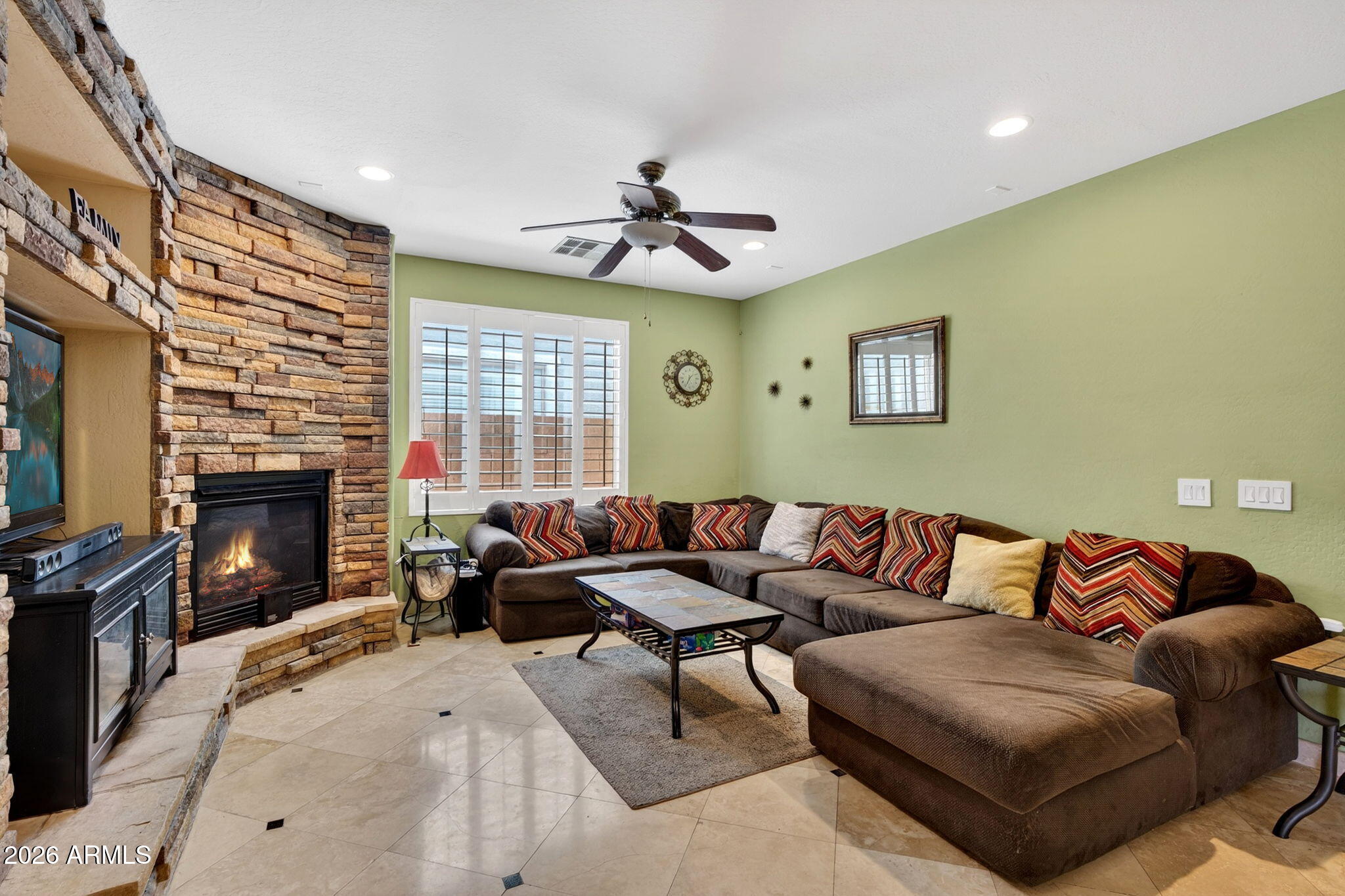 1729 South Reseda Street Gilbert, AZ 85295 - Photo 10 of 52 a living room with furniture fireplace and a flat screen tv