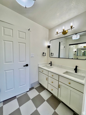 812 East Bates Cyn Road Tooele, UT 84074 - Photo 58 of 144 Bathroom featuring a double vanity with white cabinetry, gold-toned hardware, and white countertops