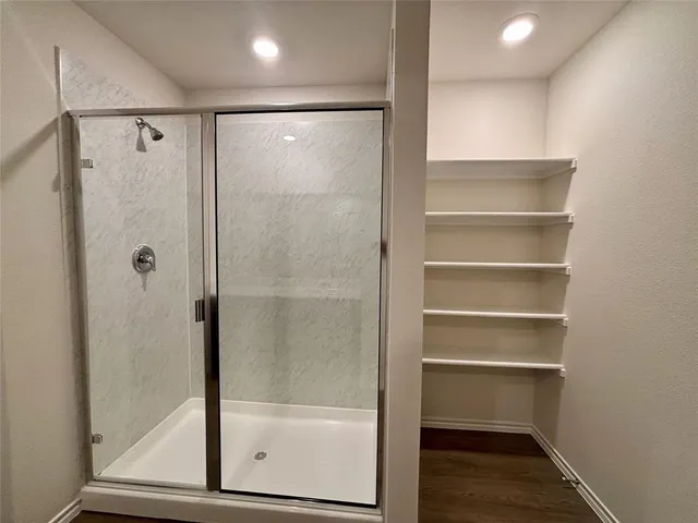 a bathroom with a sink a toilet and a shower