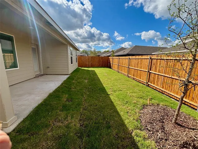 a view of backyard with a garden and plants