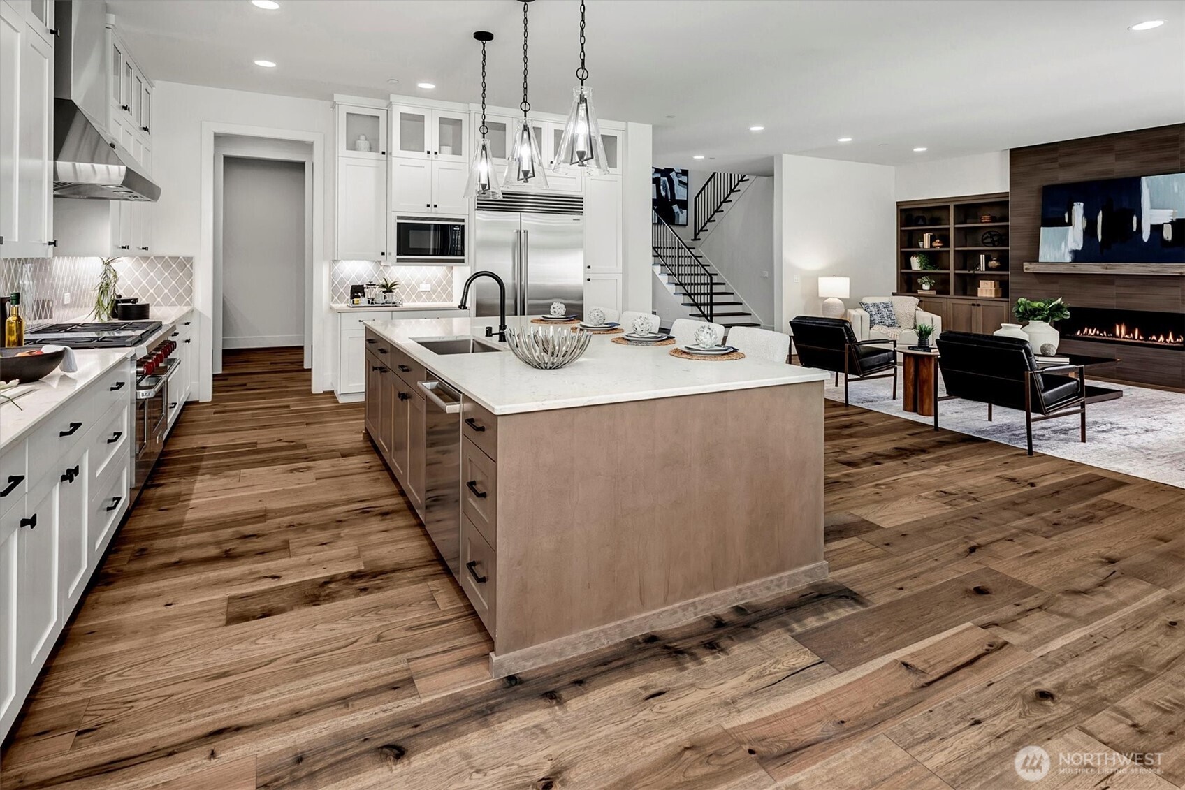 43592 Southeast 145th Street North Bend, WA 98045 - Photo 10 of 22 a large kitchen with stainless steel appliances kitchen island granite countertop a large stove a refrigerator a sink dishwasher and white cabinets with wooden floor