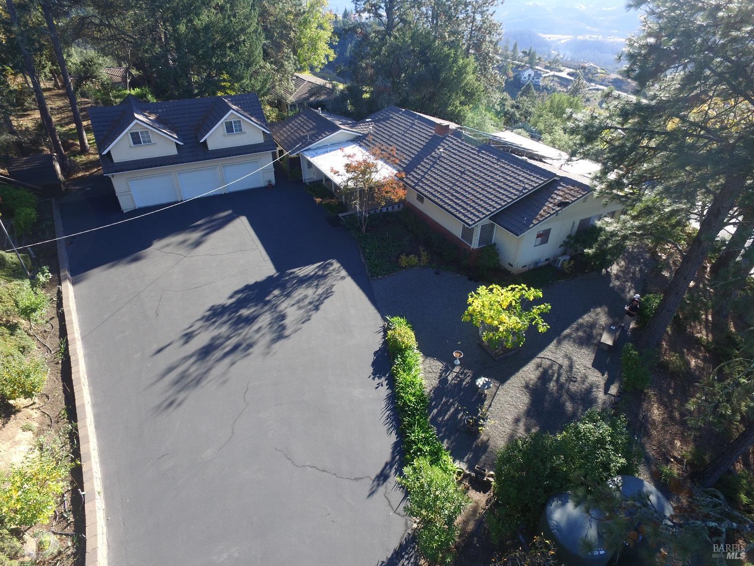 a aerial view of a house with a yard and a garden