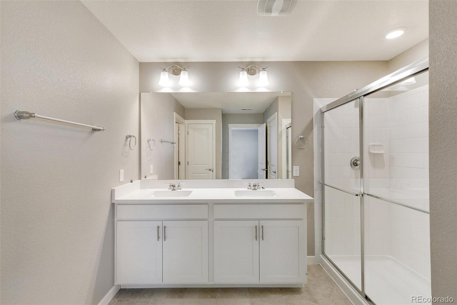 18358 Field Mint Point Parker, CO 80134 - Photo 26 of 34 a bathroom with a sink and a mirror