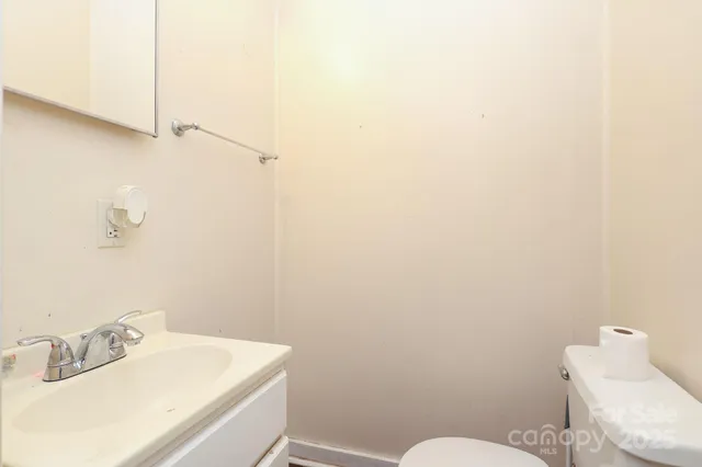 a bathroom with a sink mirror and toilet