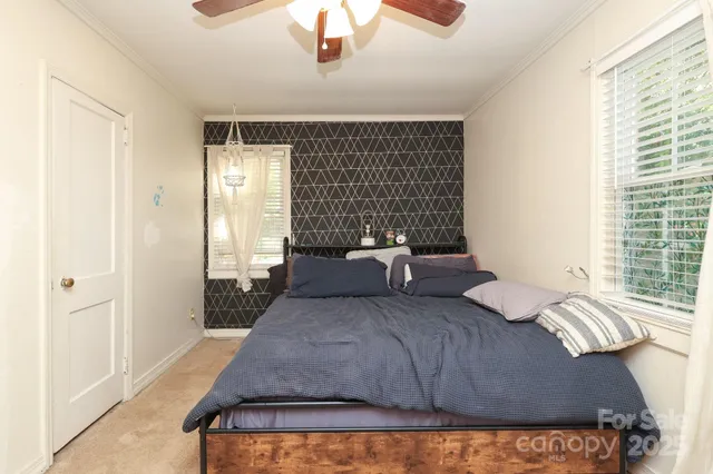 a bedroom with a bed and window