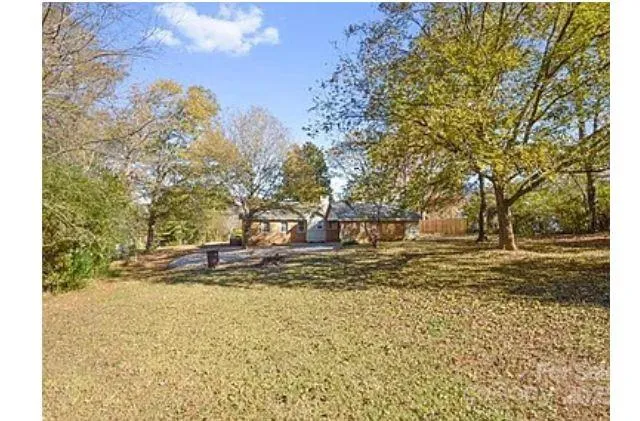 a view of a yard with a tree