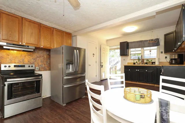 a kitchen with stainless steel appliances a stove a refrigerator and a stove top oven
