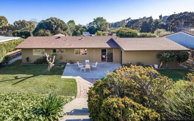 a aerial view of a house with table and chairs