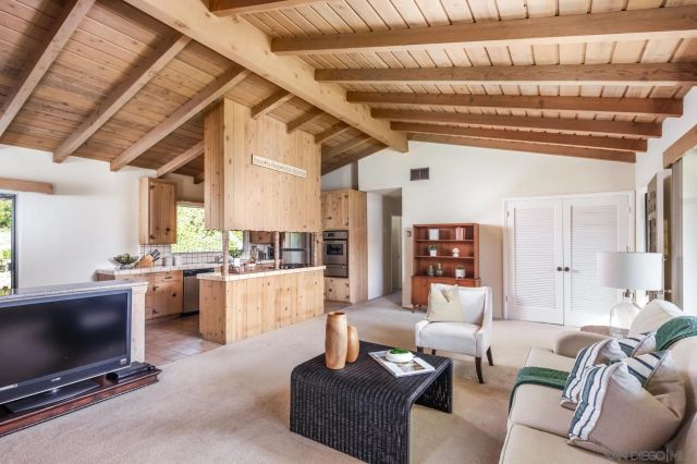 a living room with fireplace furniture and a flat screen tv