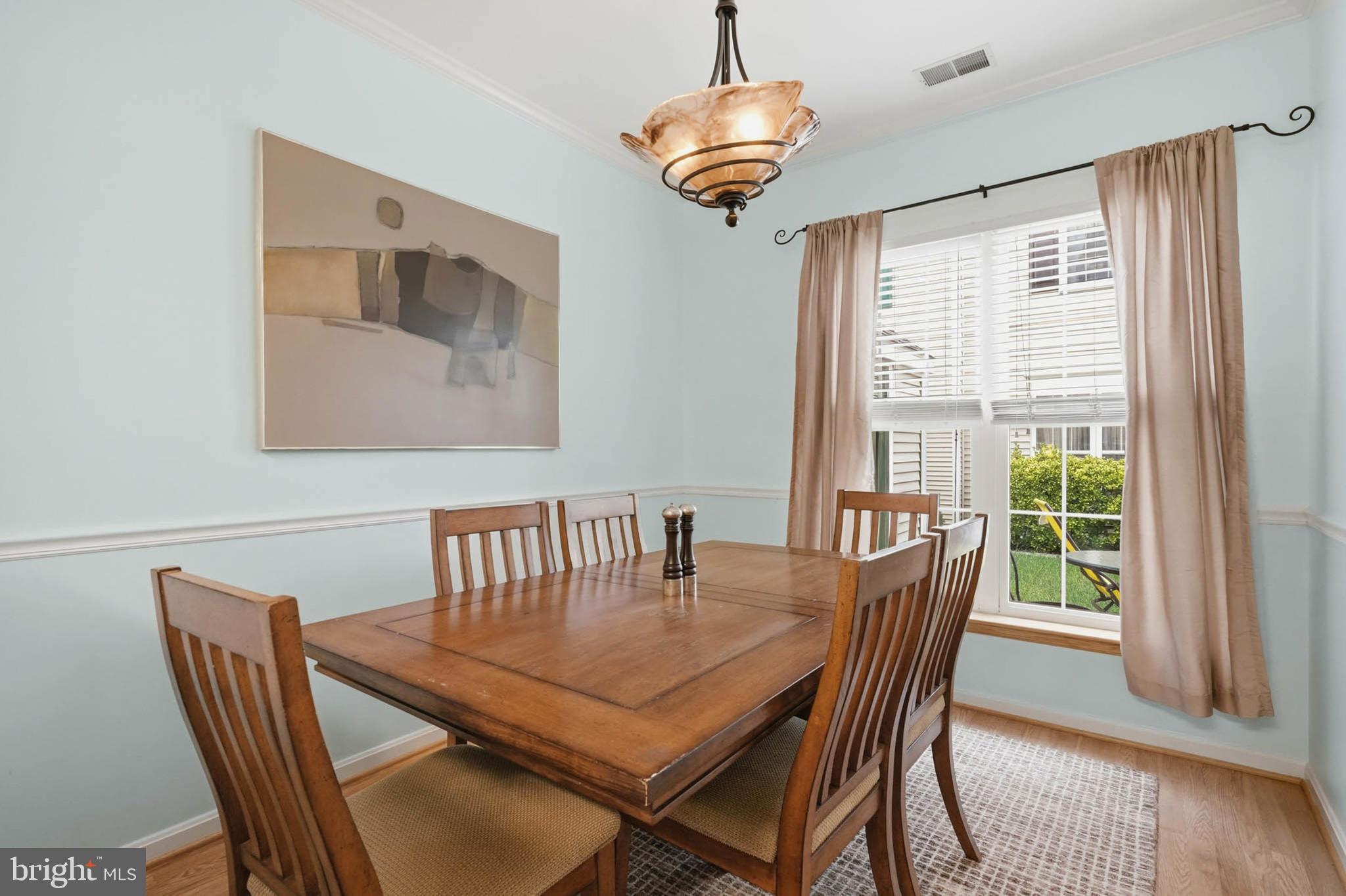8721 Spring Brook Way Odenton, MD 21113 - Photo 12 of 40 a view of a dining room with furniture window and wooden floor