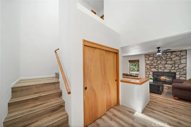 a view of a hallway with wooden floor and a fireplace