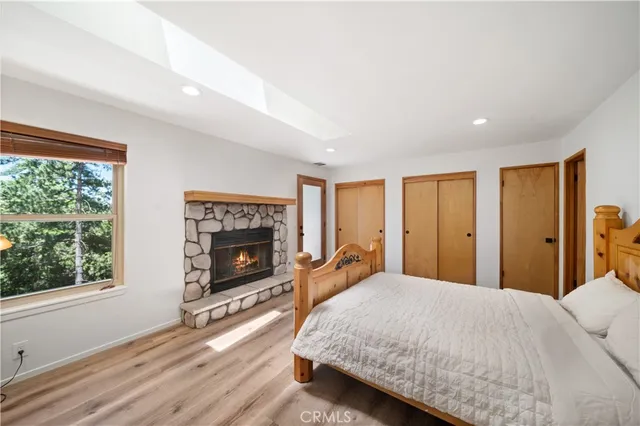 a spacious bedroom with a balcony a bed and a fireplace