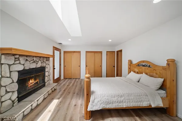 a bedroom with a bed a fireplace and a television