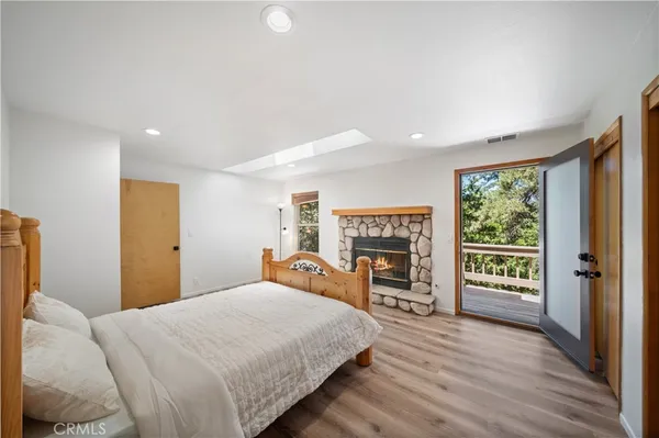 a bedroom with a large bed and a flat tv screen