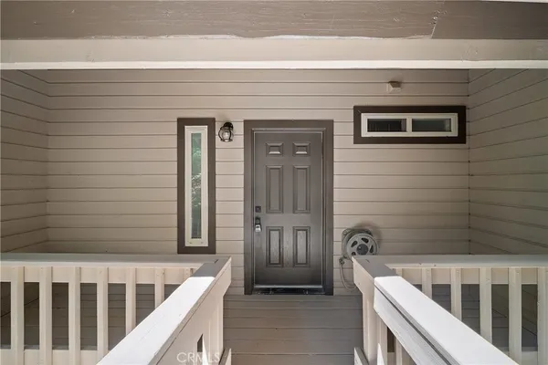 a view of a house with a small deck