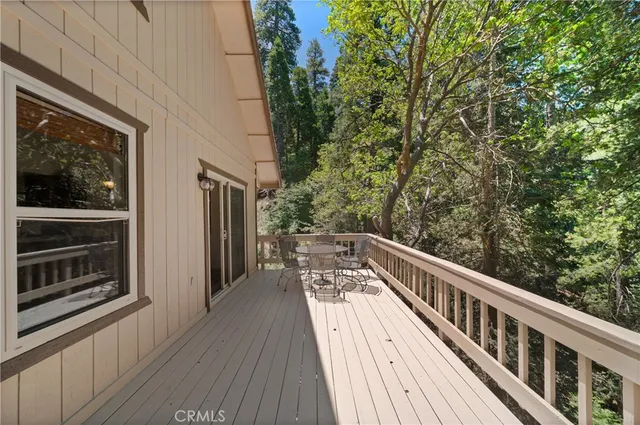 a view of balcony with wooden floor and fence
