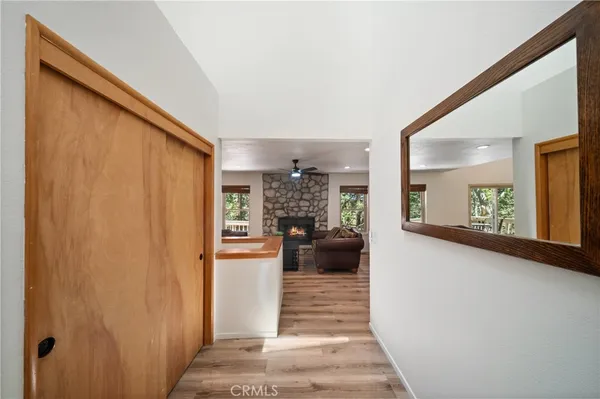 a view of a hallway and a livingroom with furniture