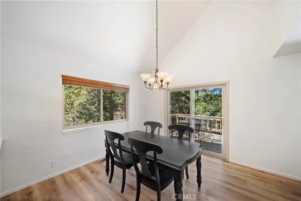 a dining room with furniture a window and a chandelier