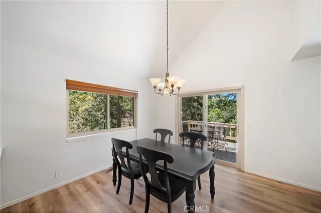 a dining room with furniture a window and a chandelier