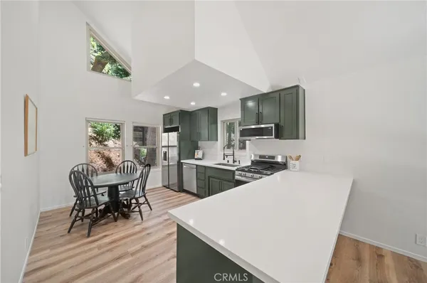 a living room with furniture a dining table and kitchen view