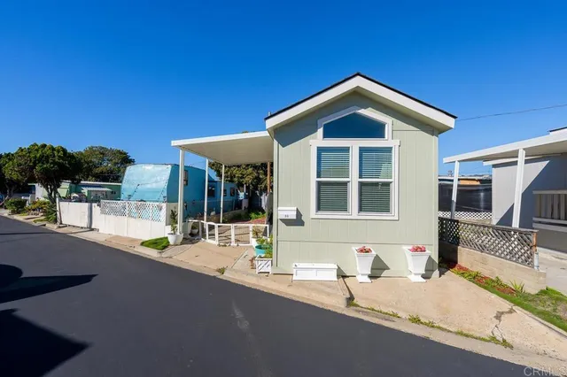 a view of a house with a swimming pool and sitting area