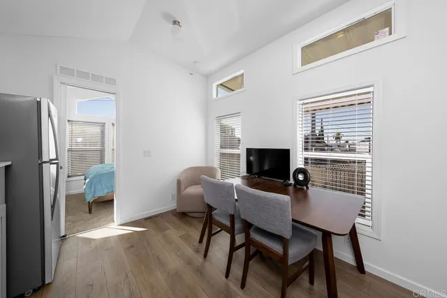 a view of a dining room with furniture a fireplace and wooden floor