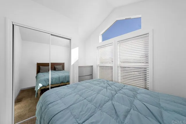 a bedroom with a bed and a closet