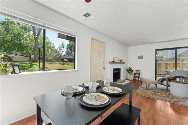 a view of a dining room with furniture window and wooden floor