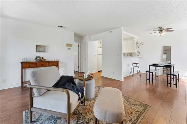 a living room with furniture and wooden floor