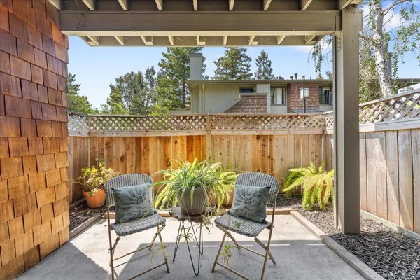 a balcony with table and chairs
