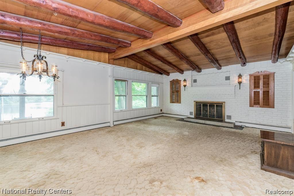 355 Ridgemont Road Oxford, MI 48370 - Photo 16 of 29 Great room with natural wood beams from the property and built with 2x6 construction for those who may opt to renovate.