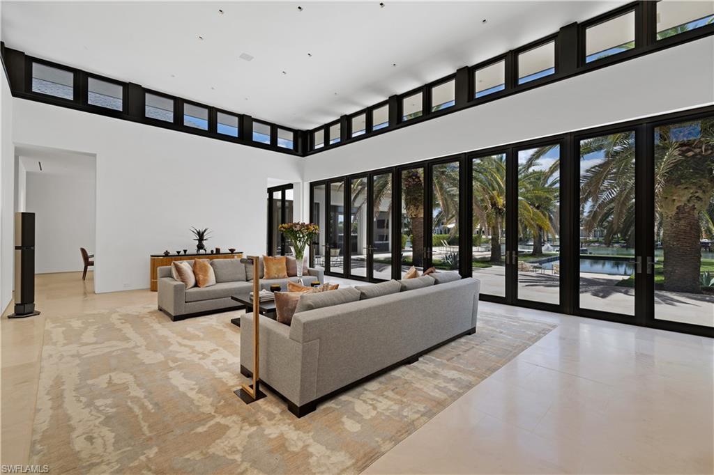 3655 Fort Charles Drive Naples, FL 34102 - Photo 11 of 50 a living room with furniture and a large window