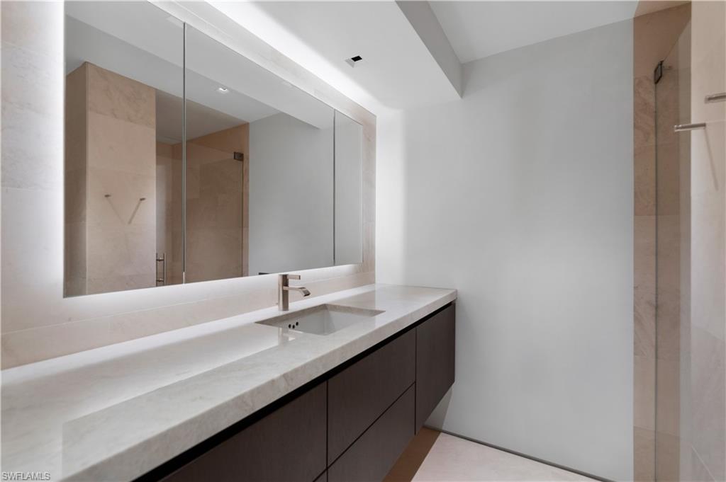 3655 Fort Charles Drive Naples, FL 34102 - Photo 18 of 50 a bathroom with a sink and a mirror