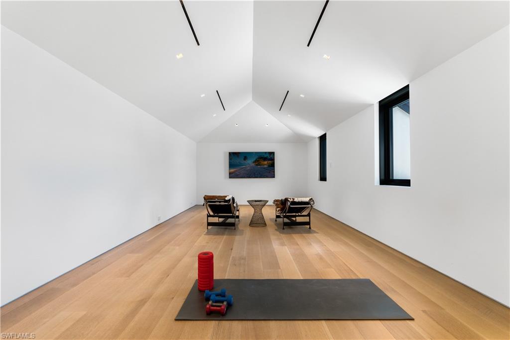3655 Fort Charles Drive Naples, FL 34102 - Photo 19 of 50 a living room with furniture and a wooden floor