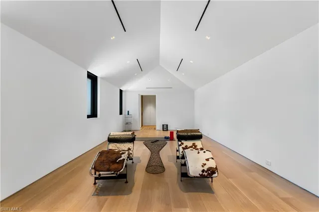 a view of a dining room with furniture and large windows