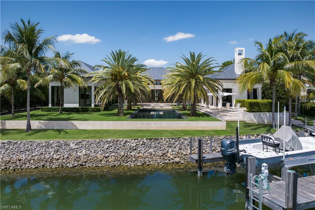 3655 Fort Charles Drive Naples, FL 34102 - Photo 31 of 50 a view of swimming pool and lake view