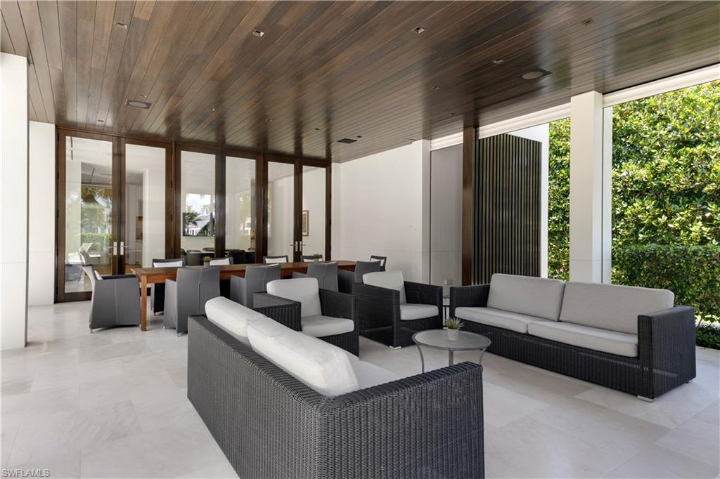 3655 Fort Charles Drive Naples, FL 34102 - Photo 37 of 50 a living room with furniture and a large window