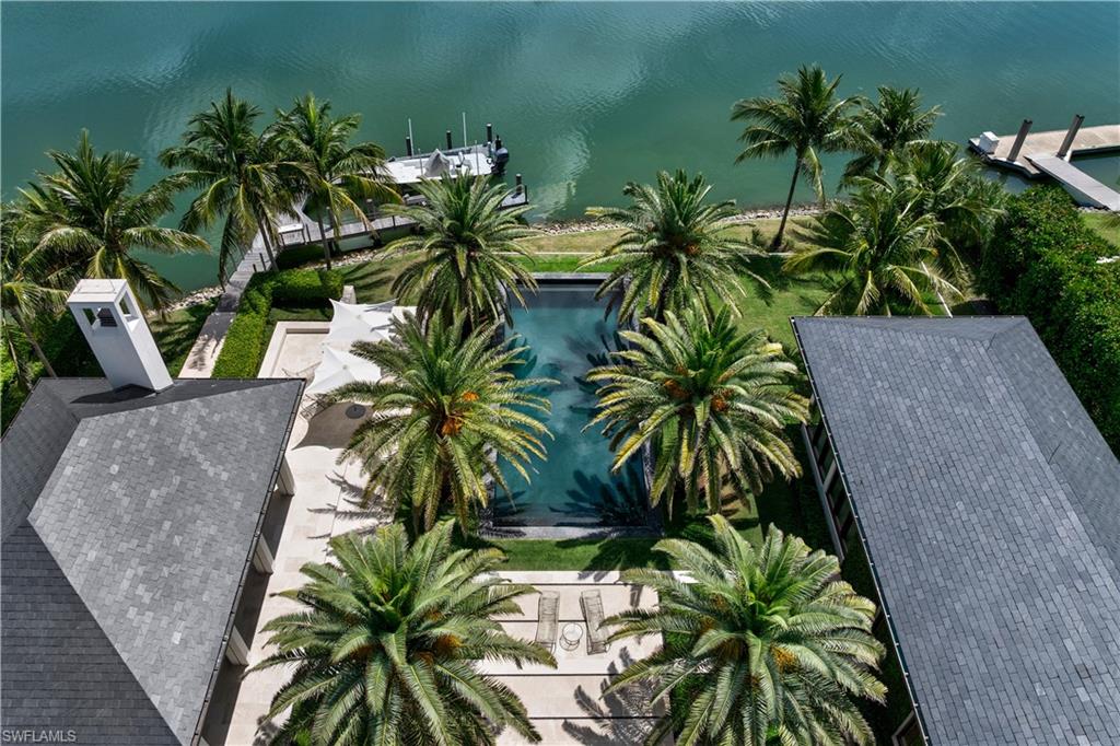 3655 Fort Charles Drive Naples, FL 34102 - Photo 40 of 50 a view of outdoor space with a garden and trees