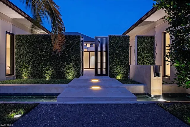 a view of backyard with potted plants and wooden fence