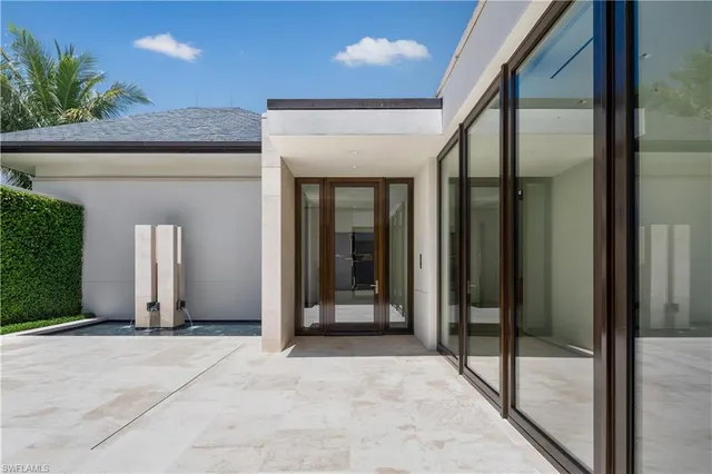a living room with furniture and large windows